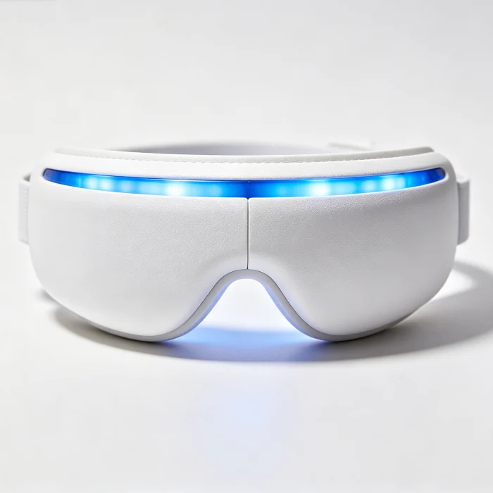 A white eye massager with blue LED lights on its side